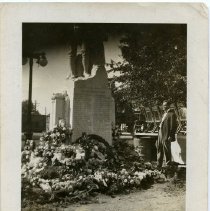 War Memorial with Flowers and an Unidentified Man